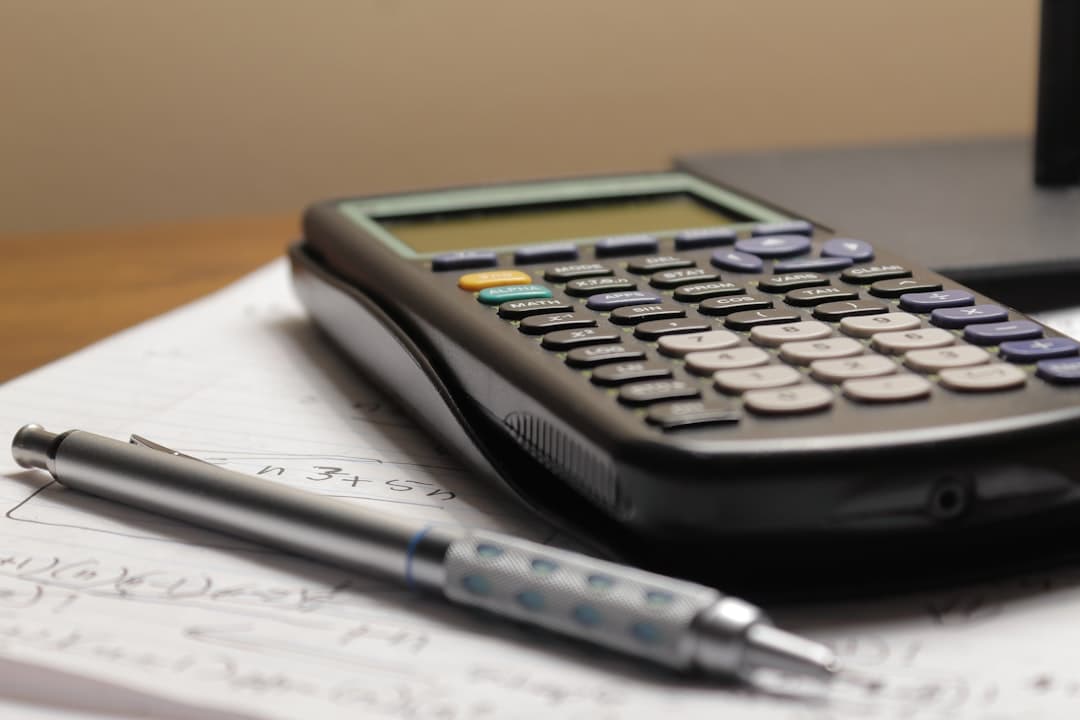 Calculator and planning notebook on a desk