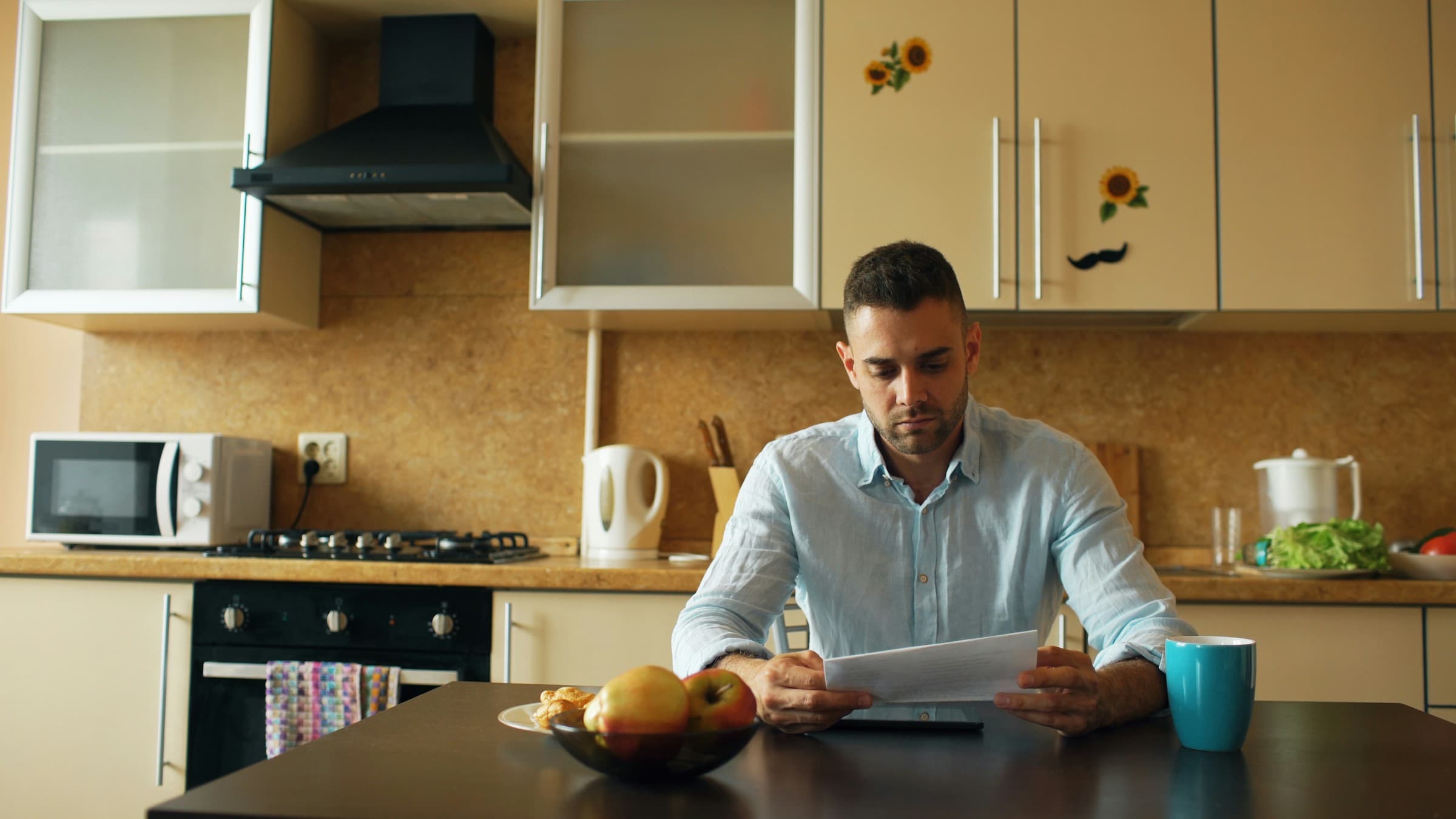 Homeowner reading a mold testing report at the kitchen table