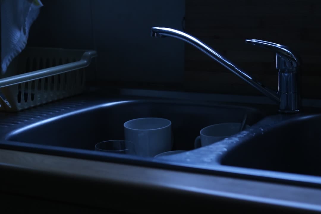 Drinking water glass at a kitchen tap