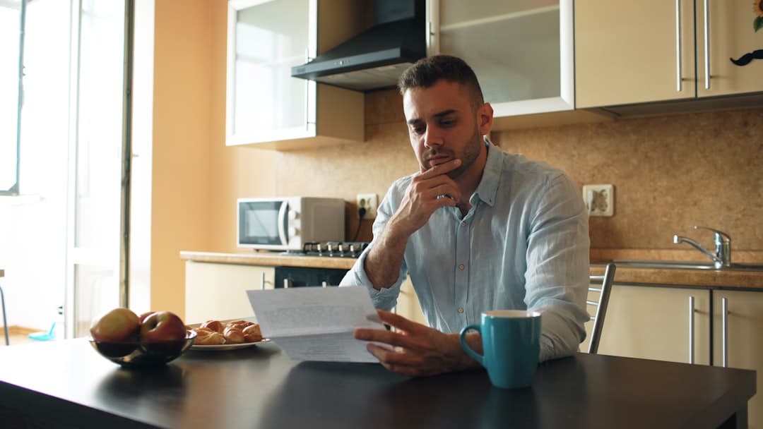 Homeowner reading a report at the kitchen table